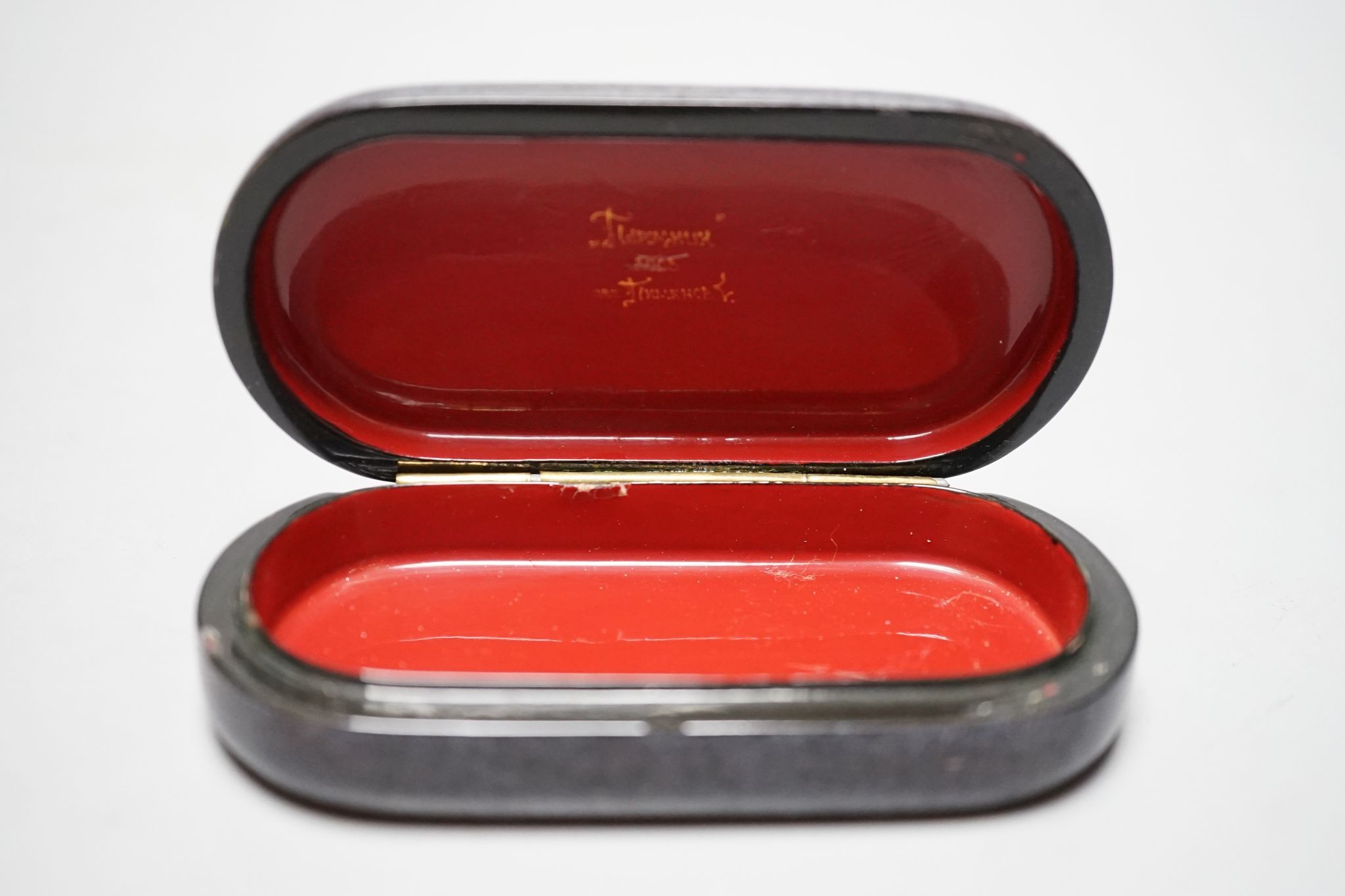 A Russian oval lacquered box, 10cm., and a porcelain box painted with ships approaching harbour